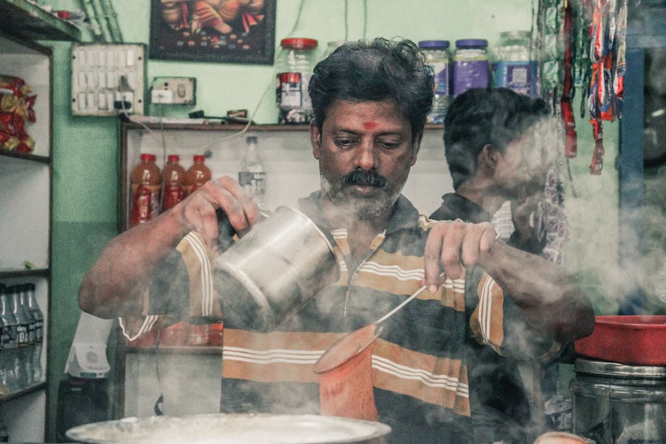 Traditional masala chai being poured with steam