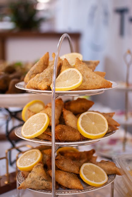 Golden samosas served on a tiered tray